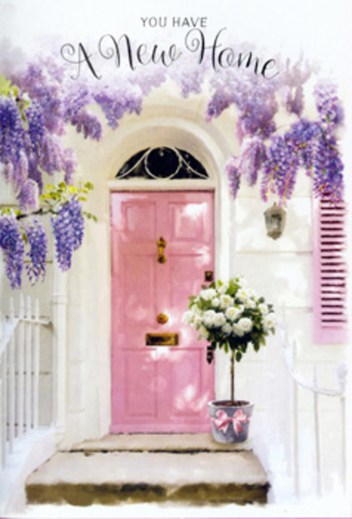 On what could be a peaceful side road in Feltham, the entrance to a new home has been transformed into a poetic little moment of celebration. A softly painted pink door stands at the centre, its hue somewhere between blush and rose, the kind of tone that changes with the daylight and pairs naturally with white walls and gentle greenery. Those whitewashed walls, faintly textured, wrap the doorway in a clean, bright frame that helps every pastel colour stand out. Above, generous strands of wisteria drape like a living garland, with tassels of lavender blossoms dangling in layered clusters. The flowers appear dense and slightly tousled, as though left to grow freely, yet they fall in lines that gracefully flank the door and soften its straight edges. A single shutter, painted to match the door, adds to the sense of cohesion and calm. At ground level, a grey metal bucket takes pride of place on the doorstep, filled to the brim with an arrangement of white and cream roses. The roses are full and open, petals layered one over another in ruffled spirals, with hints of warm ivory at their centres. Delicate green foliage threads amongst them, giving small flickers of contrast and a garden-fresh feel. Tied around the bucket is a satin pink ribbon, neat but not overly formal, its bow sitting comfortably just above the stone step. You can almost detect the soft, romantic fragrance that would drift from the roses and wisteria combined, mingling with the familiar outdoor air of Feltham. The scene feels like a housewarming gift left by a thoughtful friend or family member-perhaps delivered by Feltham Flowers-quietly marking the transition from house to home with tenderness and floral grace.