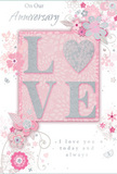 In this image, an anniversary card offers a gentle, intimate tribute to enduring love, styled in the same soft palette a Feltham florist might choose for a romantic spring arrangement. The central focus is the word LOVE, set in raised, rounded letters that feel plush and inviting. Rather than a plain O, a shimmering silver heart is placed in its stead, filled with textured glitter that makes it the brightest point on the card, like a single, standout bloom in a cluster of pastels. Each of the other letters is edged in fine, pale glitter, giving a delicate sparkle that dances in the light. Surrounding this central motif, a scattering of pastel blossoms in blush pink and gentle mauve unfurls as if painted in watercolour. Their edges are soft and slightly blurred, blending into a powdery pink and silvery-grey background that feels quiet and romantic. Thin, flowing stems and vines weave through the design, accented by tiny petals, curls, and almost-hidden butterflies, creating an impression of motion, as though a light breeze were moving through an English garden on a mild day in Feltham. Above and below the flowers, elegant script phrases such as On Our Anniversary and I love you today and always appear in a refined, flowing typeface. The script echoes the curves of the vines and adds a verbal counterpart to the visual softness. The overall composition is balanced and airy, giving the sense of a cherished keepsake meant to be displayed alongside fresh anniversary flowers on a Feltham mantelpiece, soft as a whispered promise yet deeply heartfelt in its details.